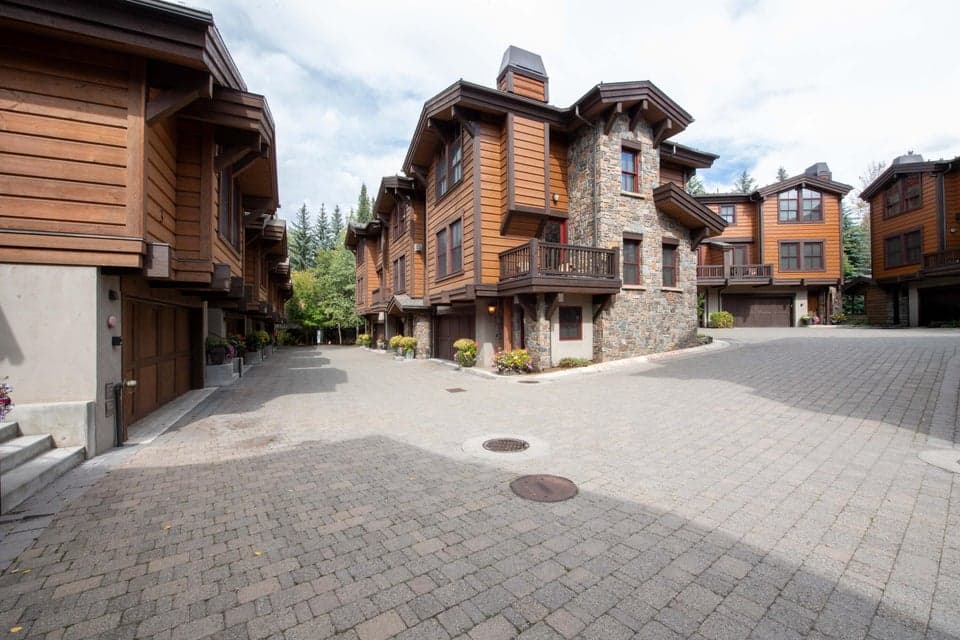 409 S Main St 4C — Ski View Townhomes Exterior & Heated Paver Driveway. Ketchum, ID. Showcasing striking stone and wood architecture, this turnkey Ketchum townhome features a heated paver driveway and attached 2-car garage, eliminating snow hassle just 0.7 miles from River Run Lodge.