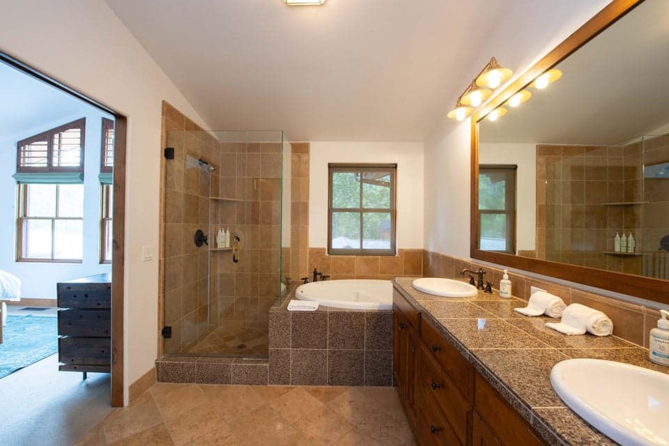 409 S Main St 4C — Spa-Inspired Primary Ensuite Bathroom. 409 S Main St #4C, Ketchum. Featuring elegant stone accents and refined finishes, this luxurious ensuite bath offers a spa-like retreat for total rejuvenation after a day on the slopes, just minutes from downtown Ketchum and River Run Lodge.